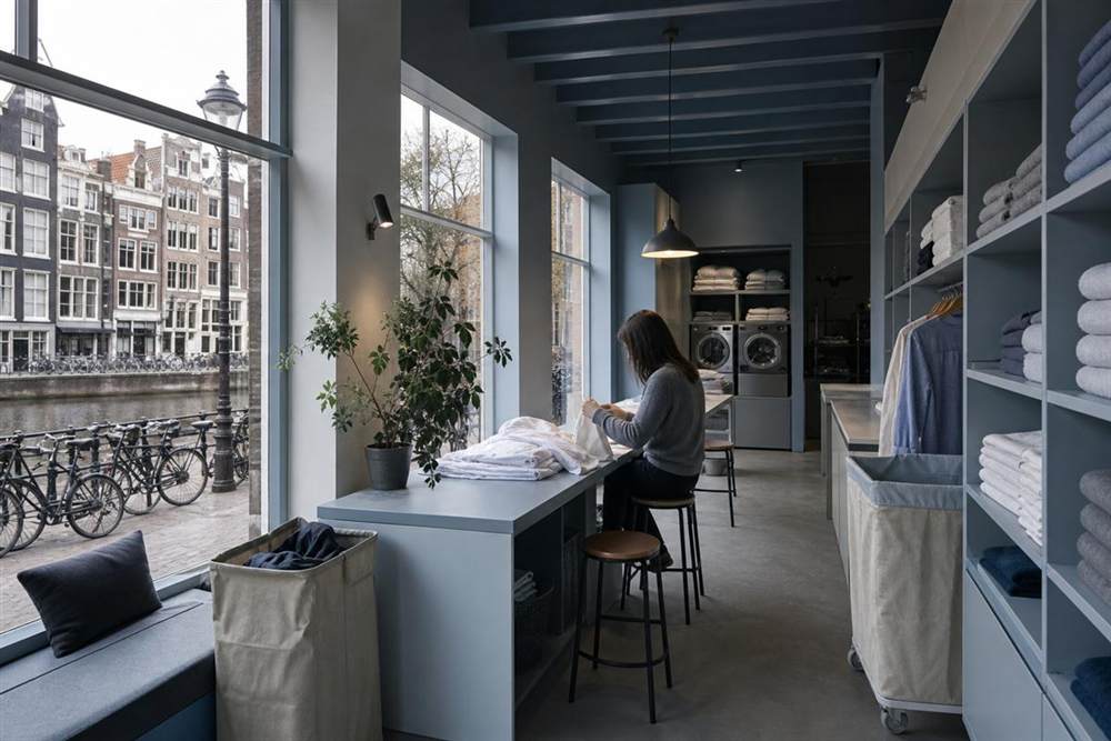 Laundry atelier with folded linens by the window